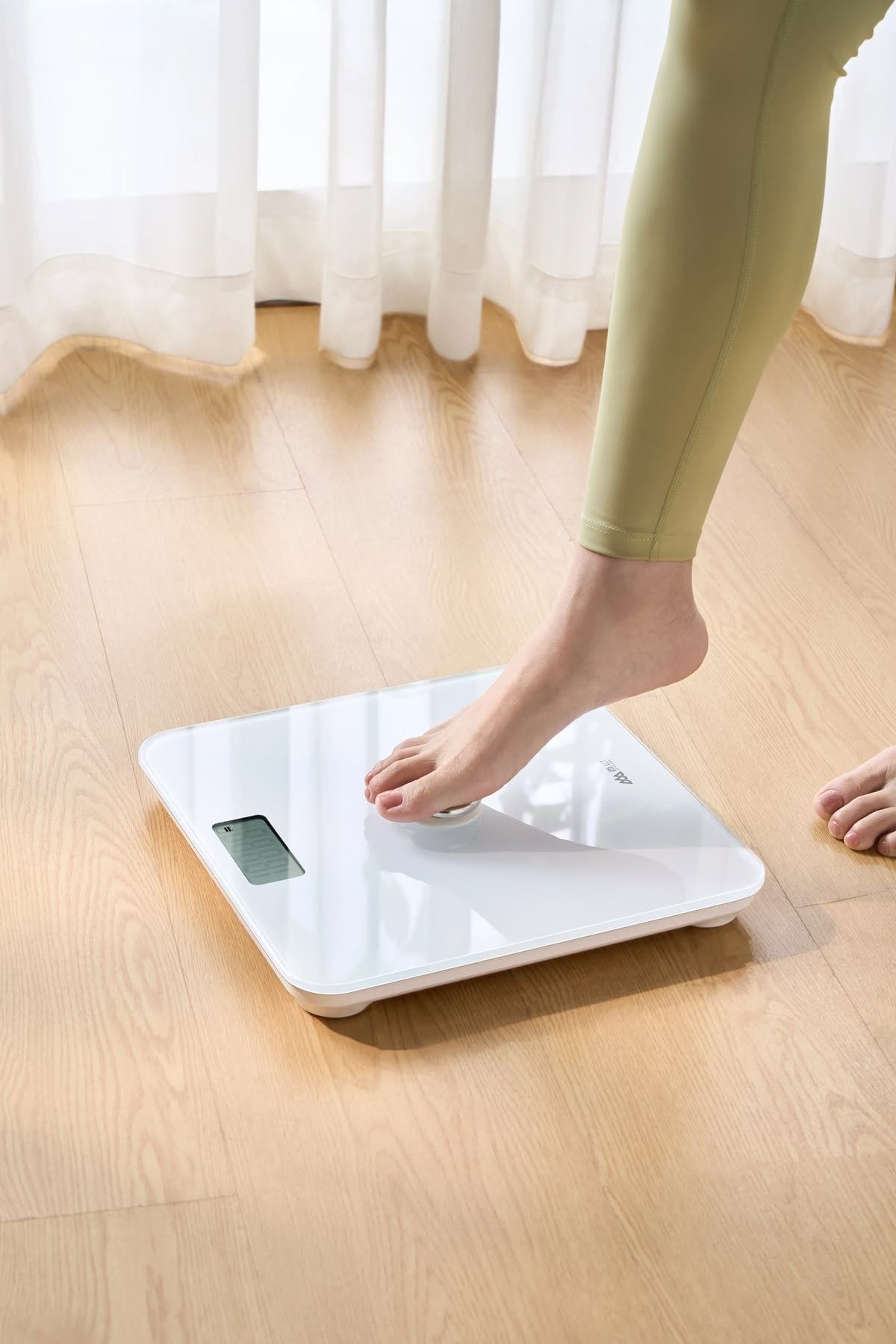 Pessoa ajustando uma balança digital em casa